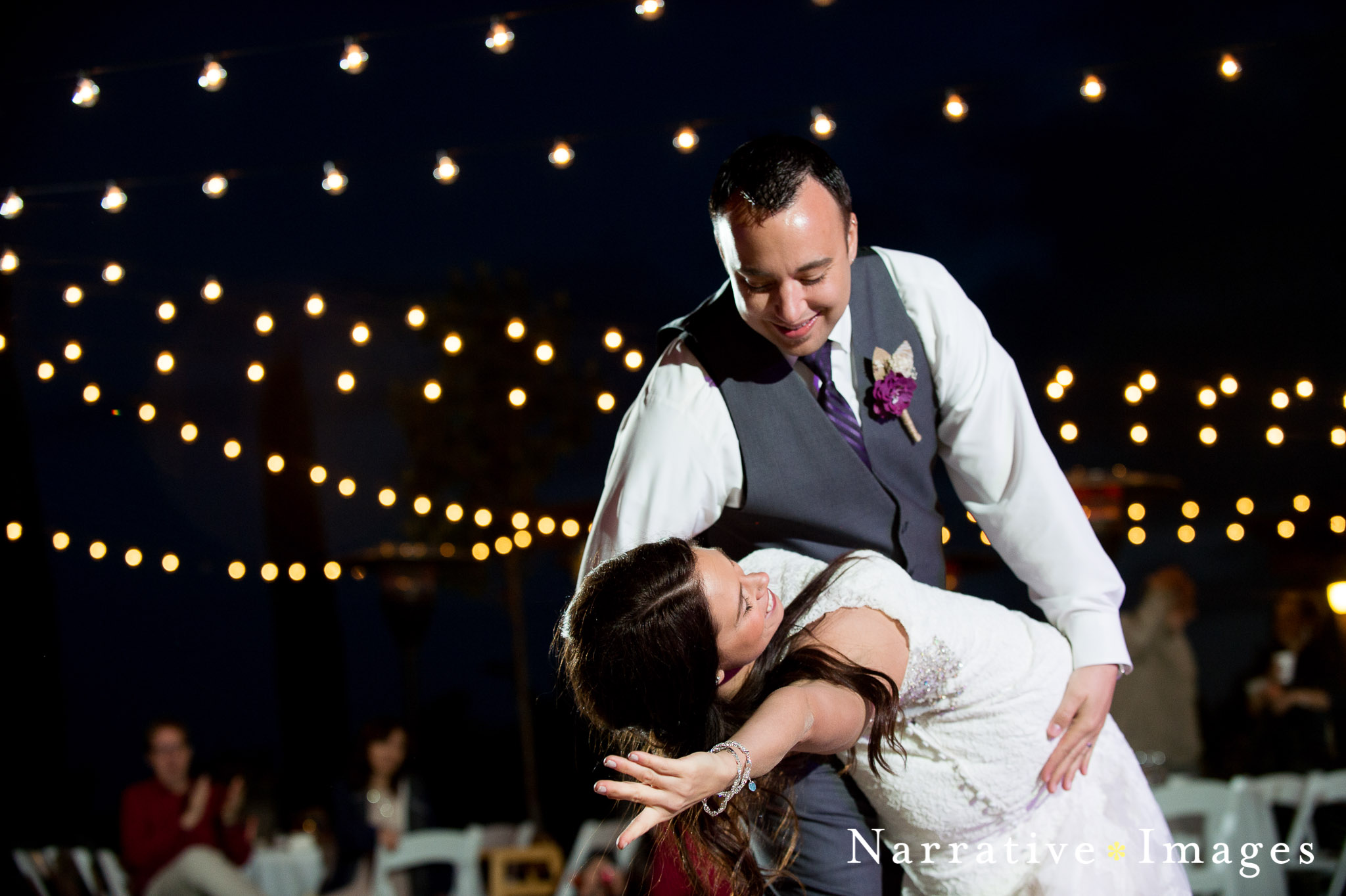 photojournalistic wedding photo of Groom dipping bride at end of first dance at mount Palomar winery wedding reception 