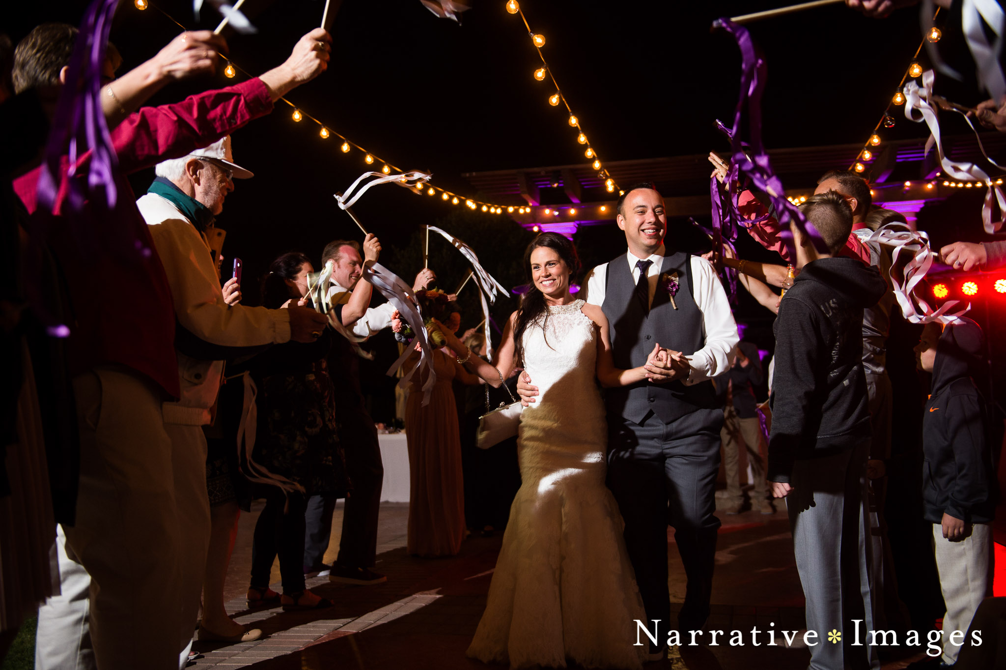 Grand exit of bride and groom after wedding reception at mt palomar winery while guests cheer on married couple