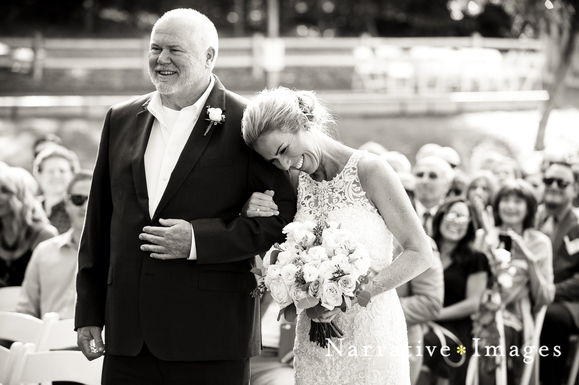 Emotional bride laughs as she walks down the aisle with her father