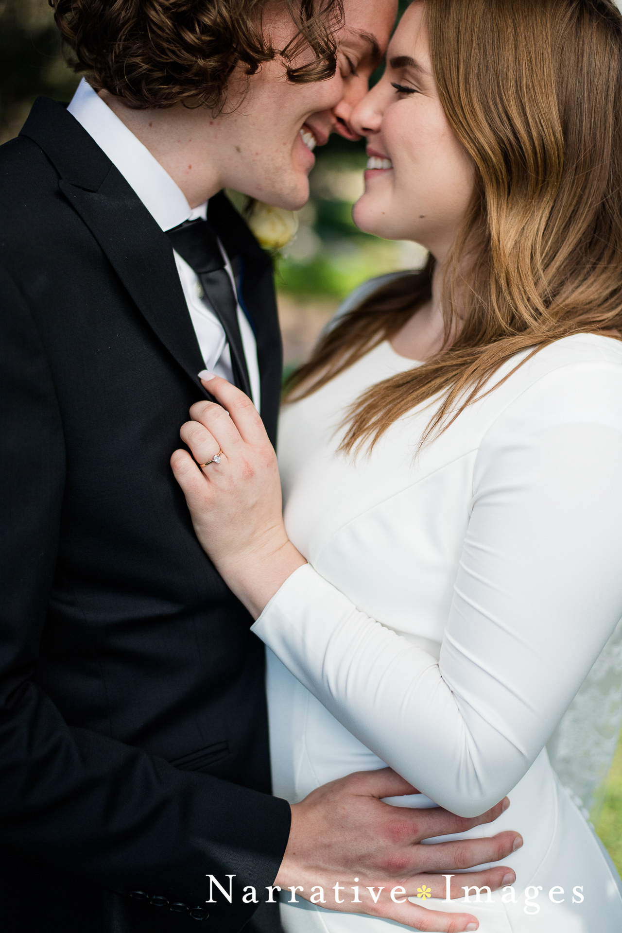 mormon bride with long sleeve dress embraces her groom