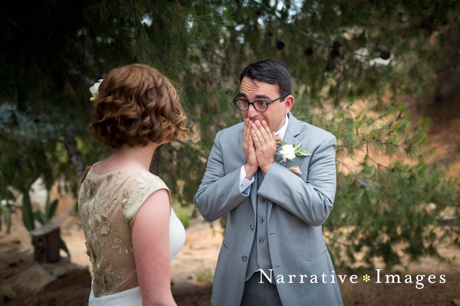 Emotional reaction as groom sees his bride during first look at Mount Woodson Castle in Ramona