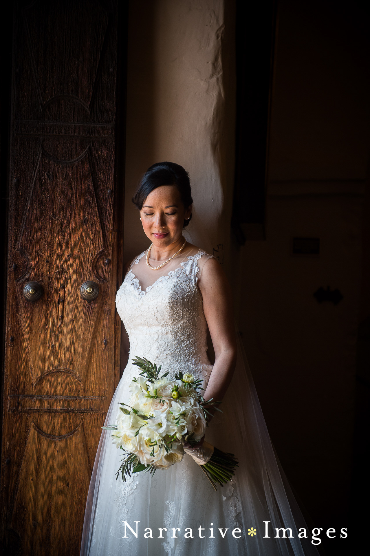Portrait of bride in front of doors at Mission San Diego de Alcala