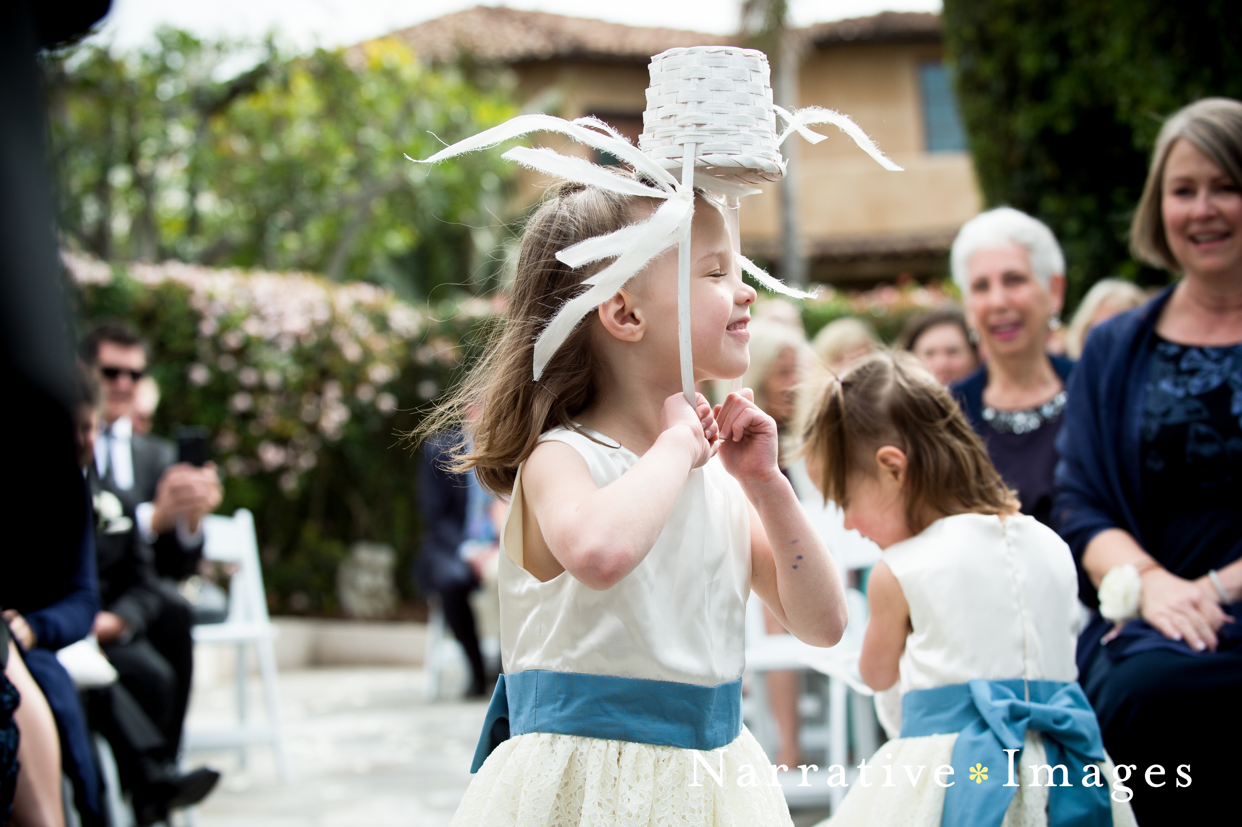 Flower girl hold basket over head at Thursday Club in Point Loma