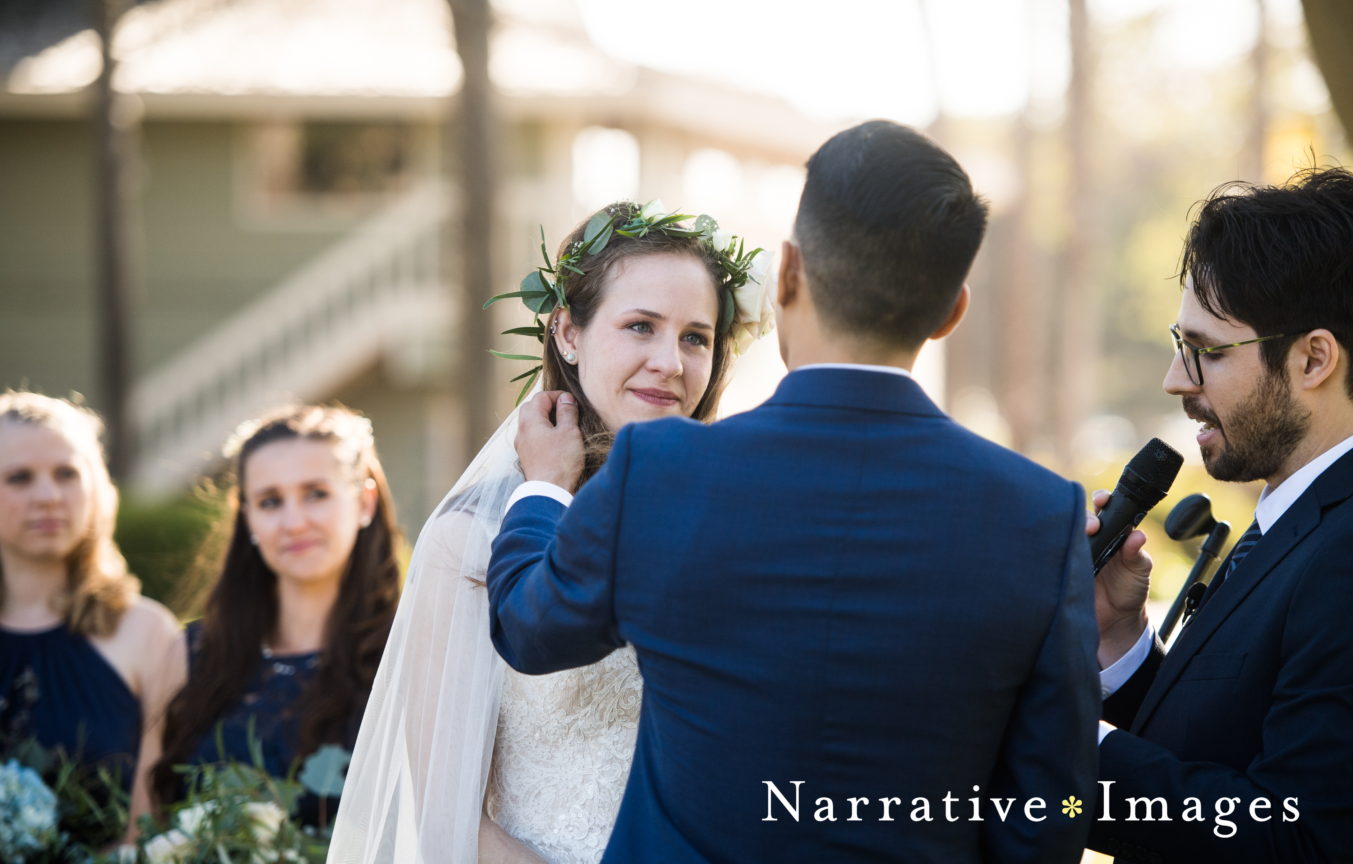 Groom pushes bride's hair back during ceremony at Marina Village in Mission Beach San Diego