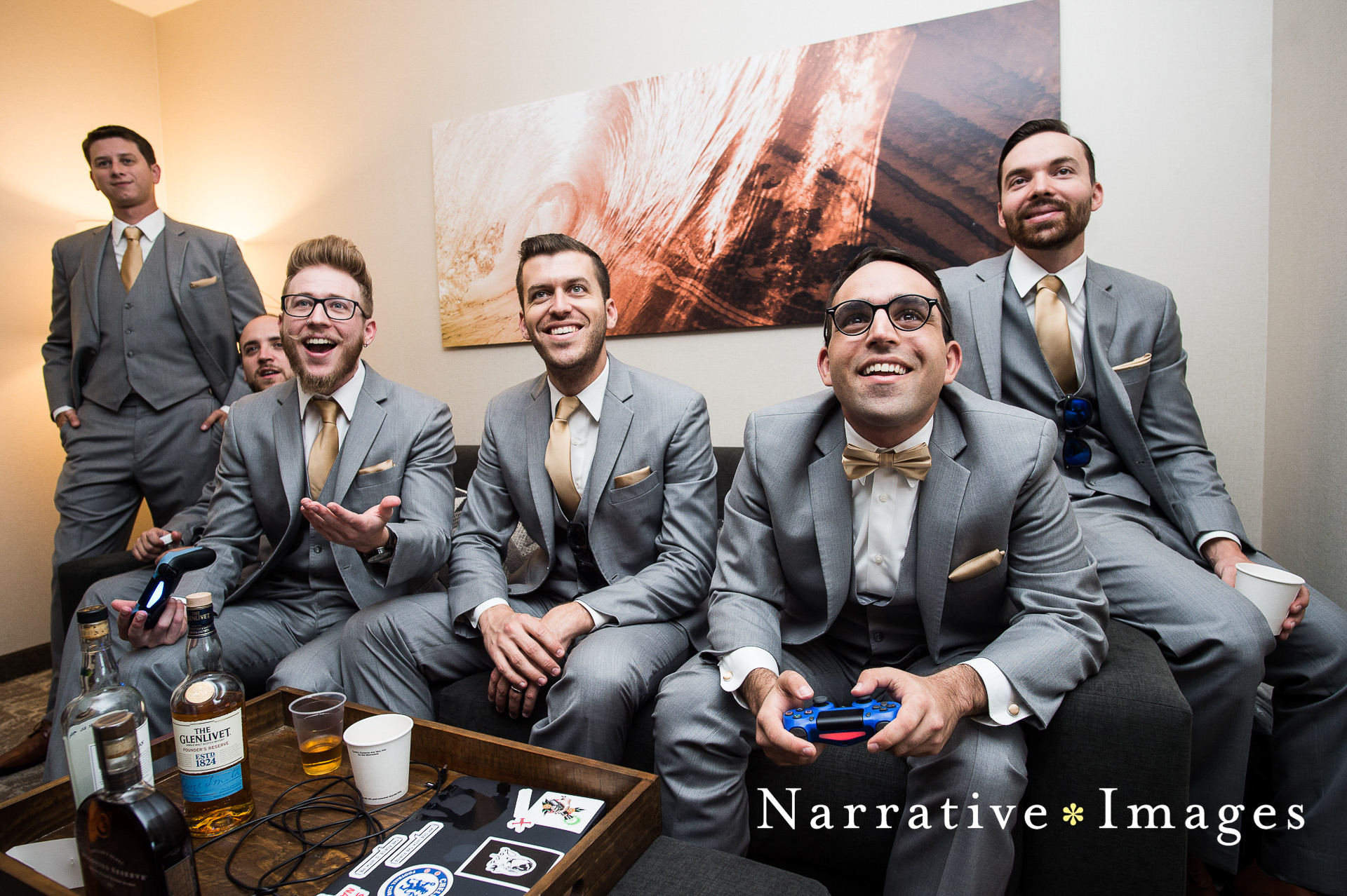 Groomsmen play video games in their suits