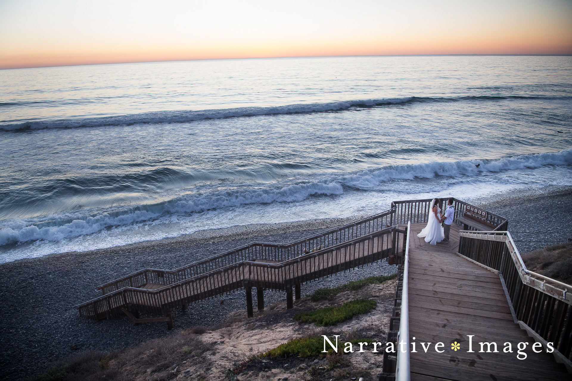 Bride and groom on long steps to beach after wedding ceremony at Cape Rey in Carlsbad