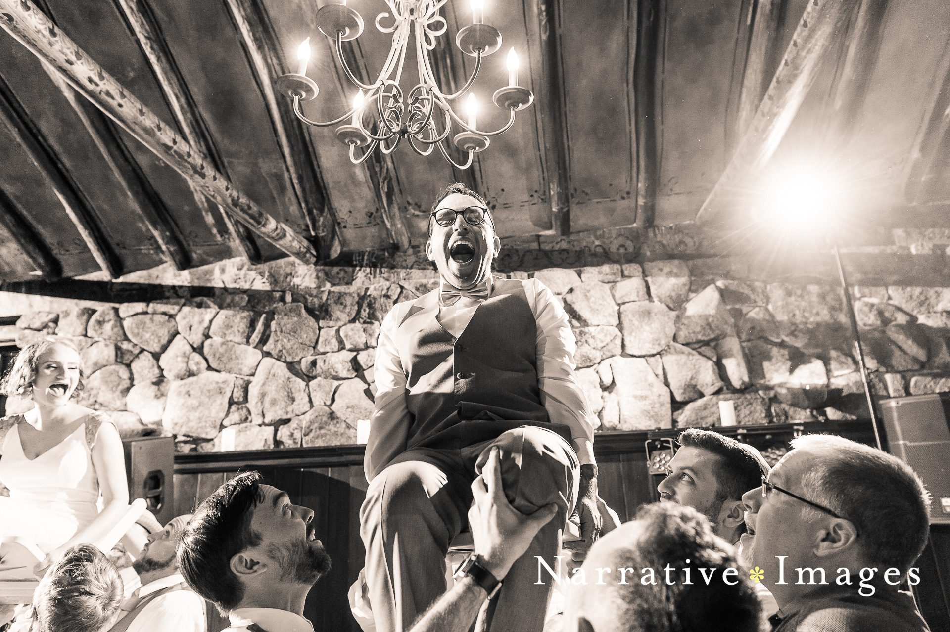 Groom up on the chair during horah dance at Mount Woodson Castle