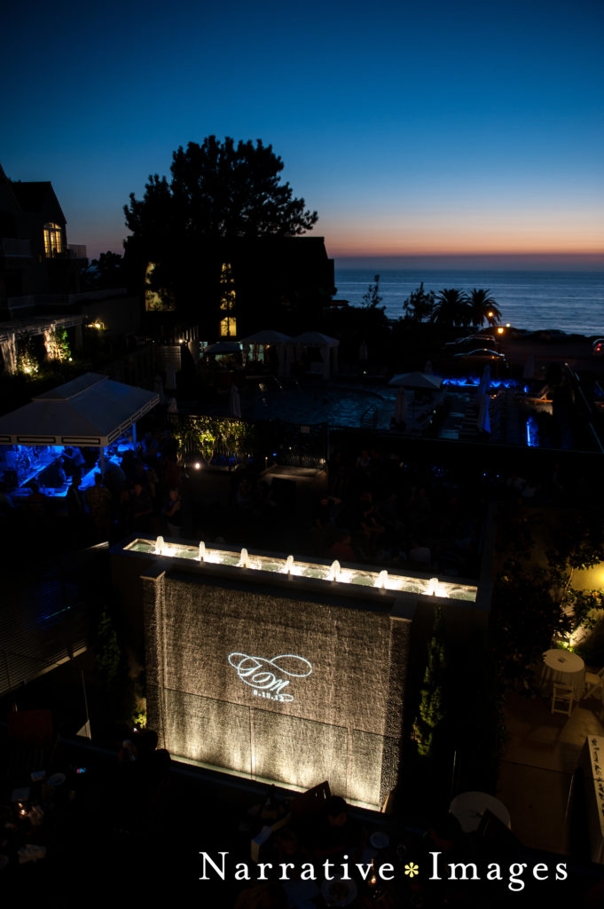 Water fountain at night with gobo monogram at wedding at L'Auberge Del Mar