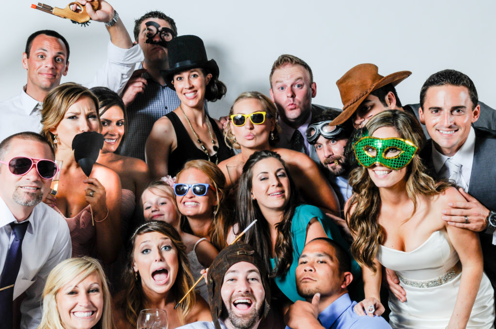 Silly photo booth photo of group of guests at wedding at Scripps Seaside Forum in La Jolla, California