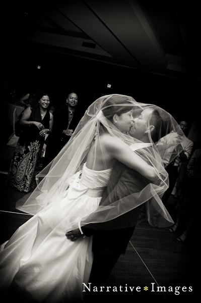 Bride and groom kissing in black and white photo