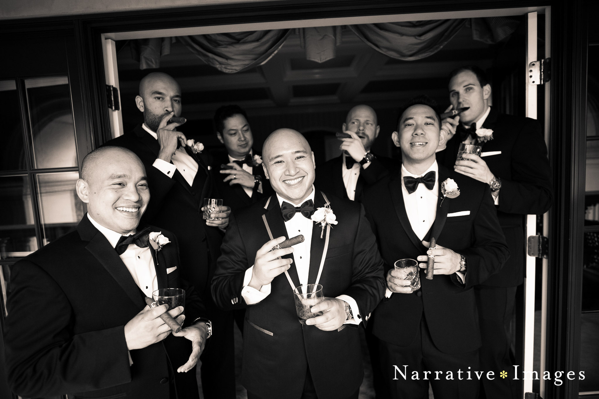 Wedding photo from the grand del marl hotel classic style black tie groomsmen hold cigars and whisky