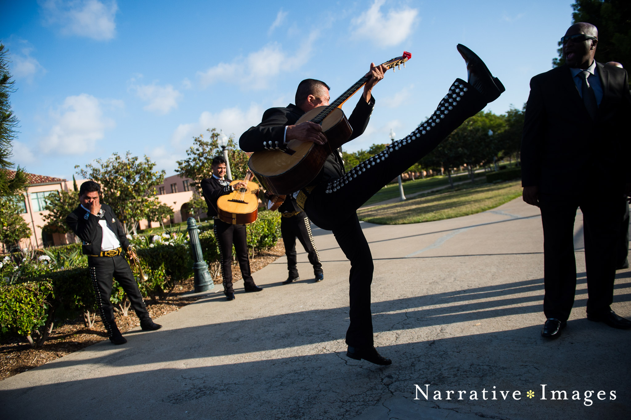 Mariachi jumps in air with guitar at Wedding at NTC Chapel