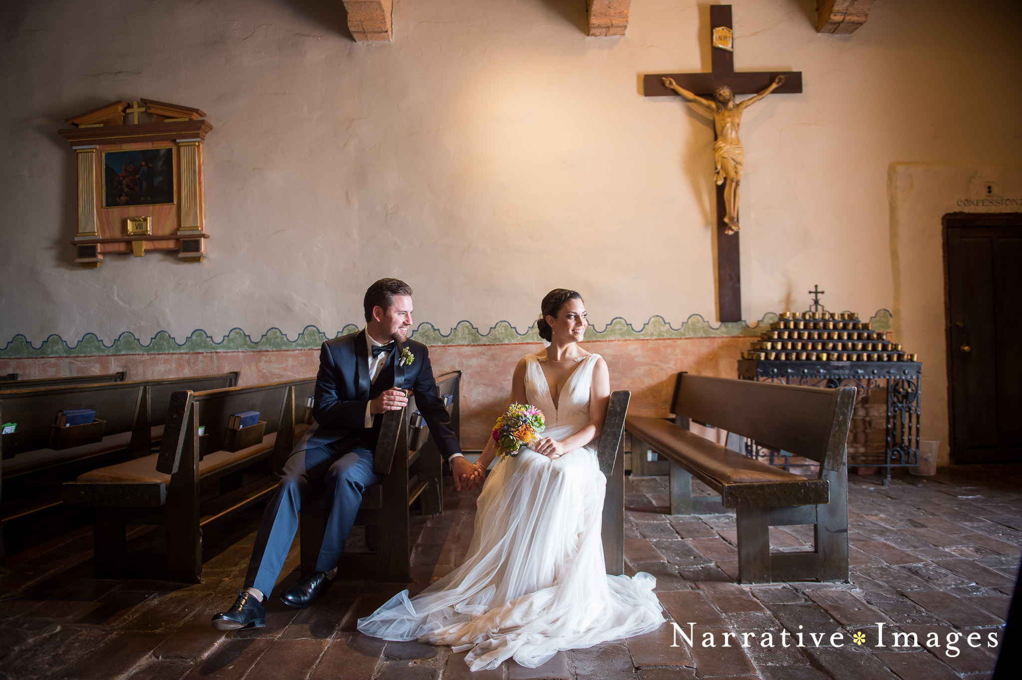 Bride and Groom sit in pews after their wedding at the Mission San Diego De Acala