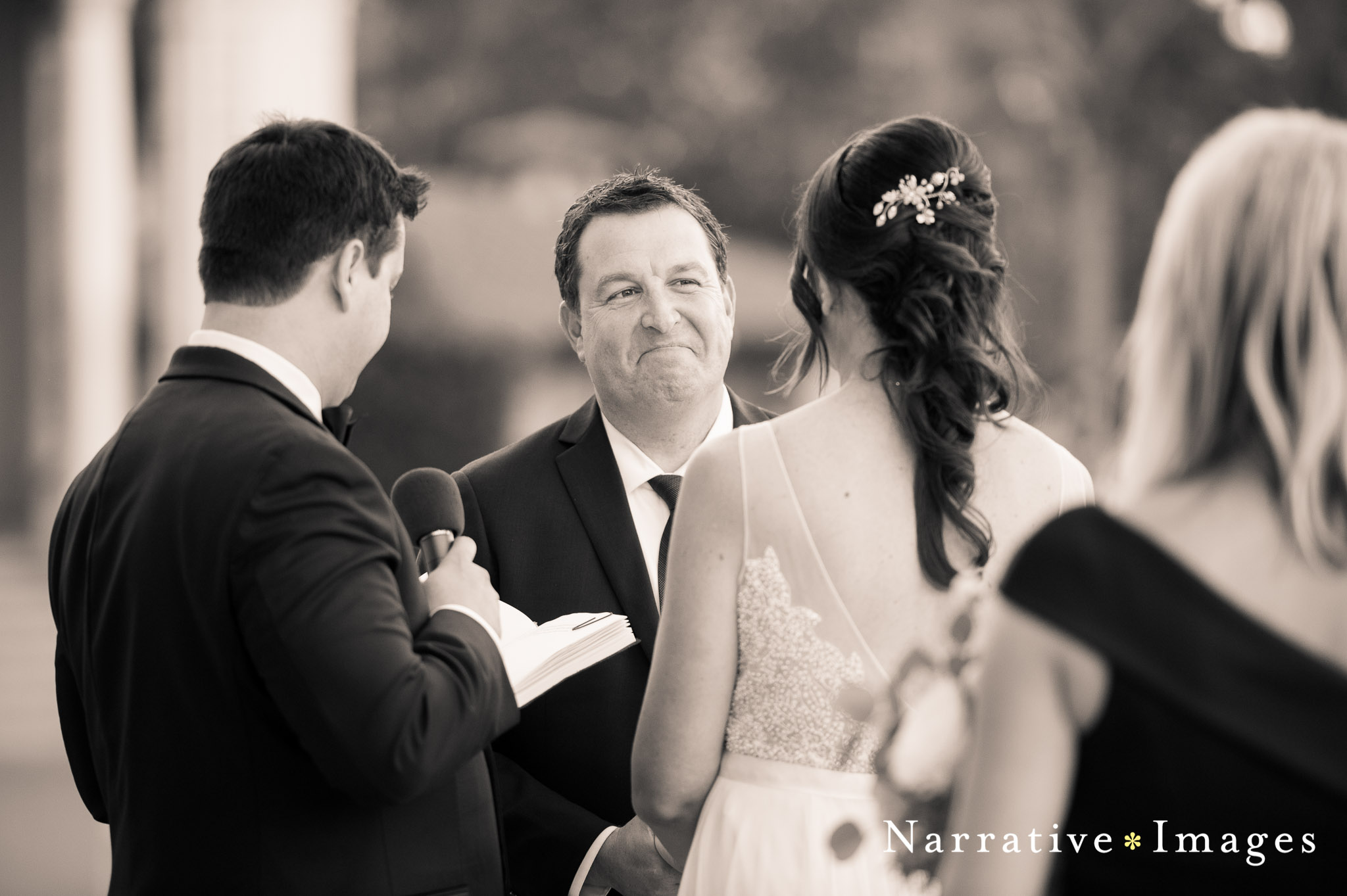 Groom looks lovingly at his bride during ceremony on stage at Spreckels Organ Pavilion 
