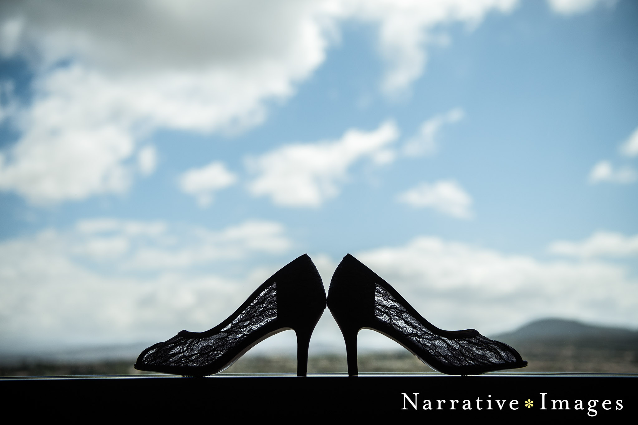 lace wedding shoes in window with clouds in background at Temecula winery wedding 