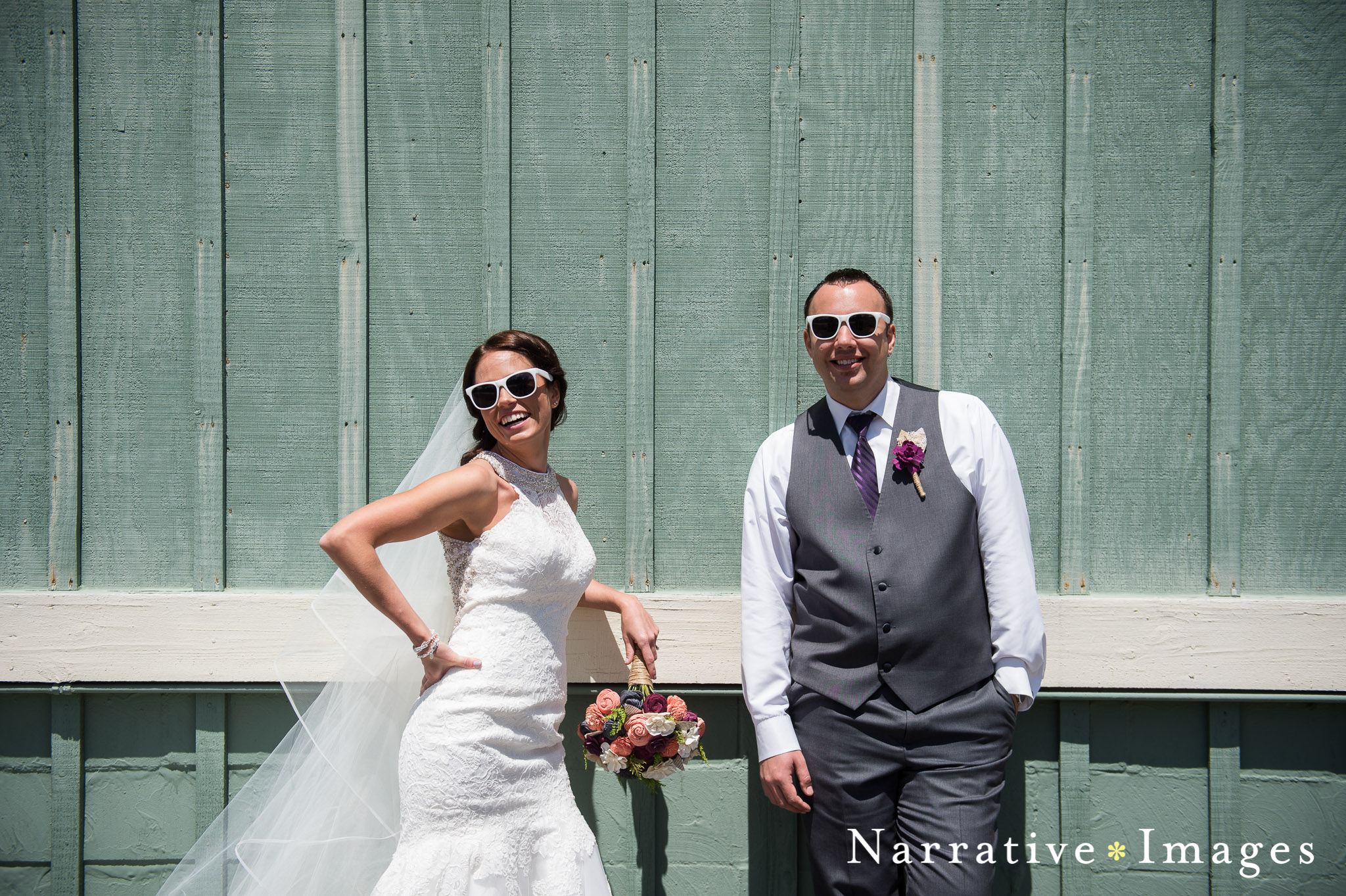 Wedding couple with sunglasses on against rustic wall for creative wedding photos in temecula ca