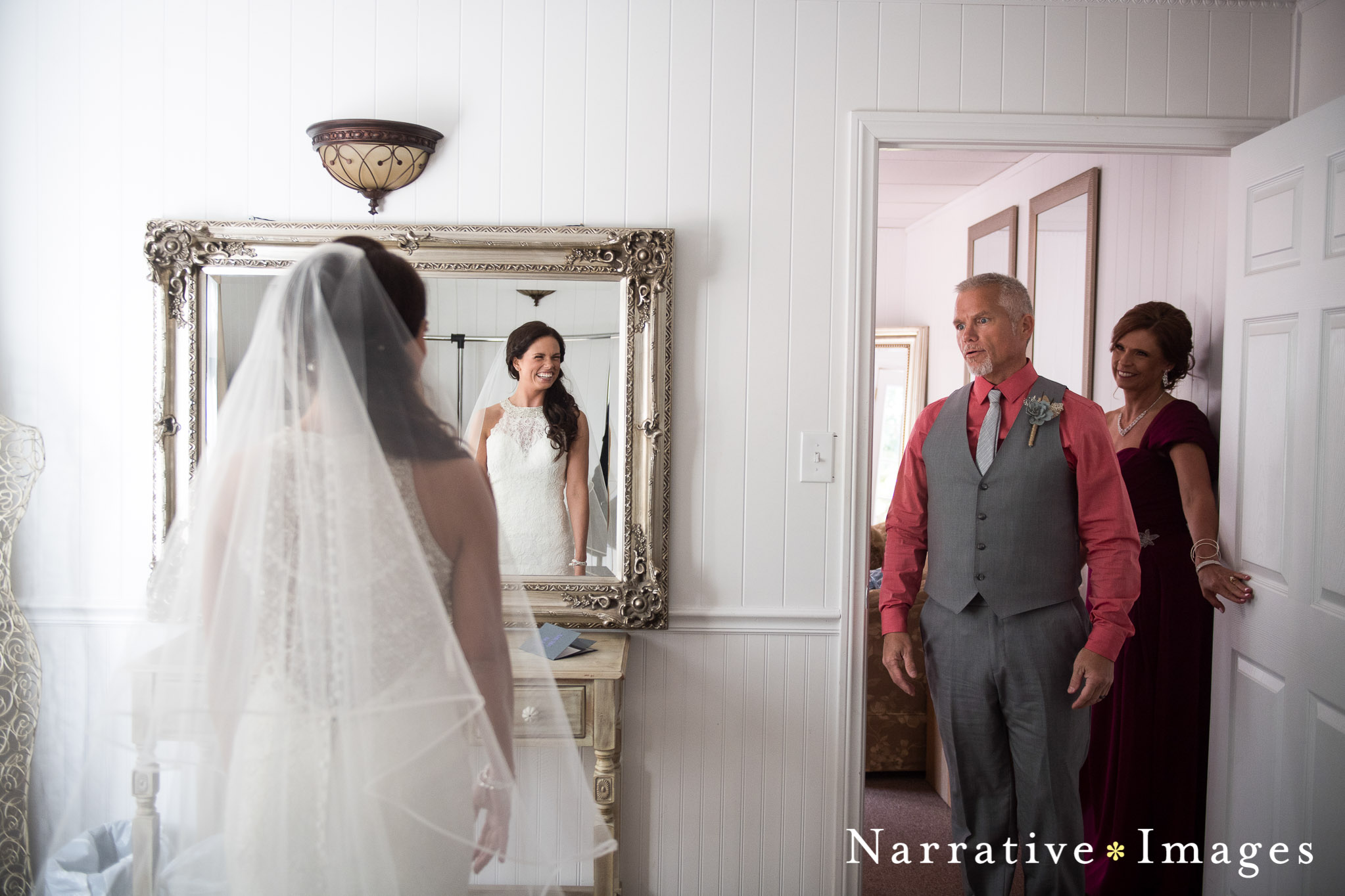 The father of the bride sees his daughter in her wedding dress on their wedding day