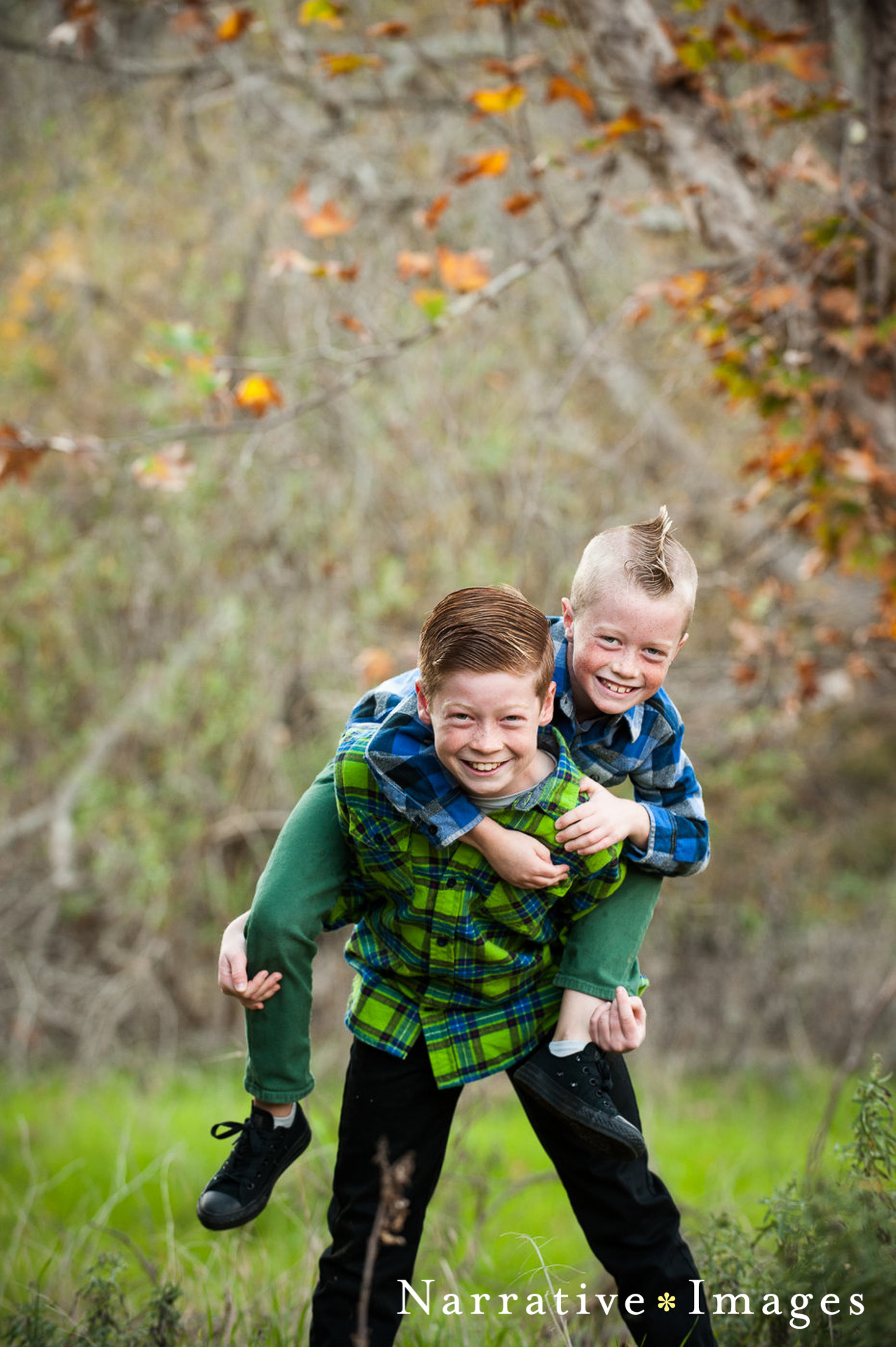 Brothers in plaid piggyback for photo at Mission Trails