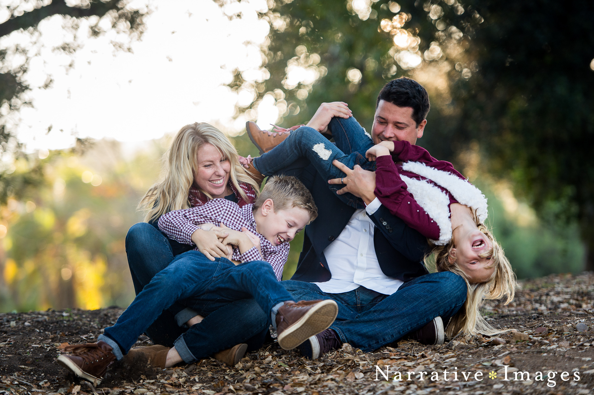 parents tickle kids in fun family photo at Redwood Circle in Balboa Park