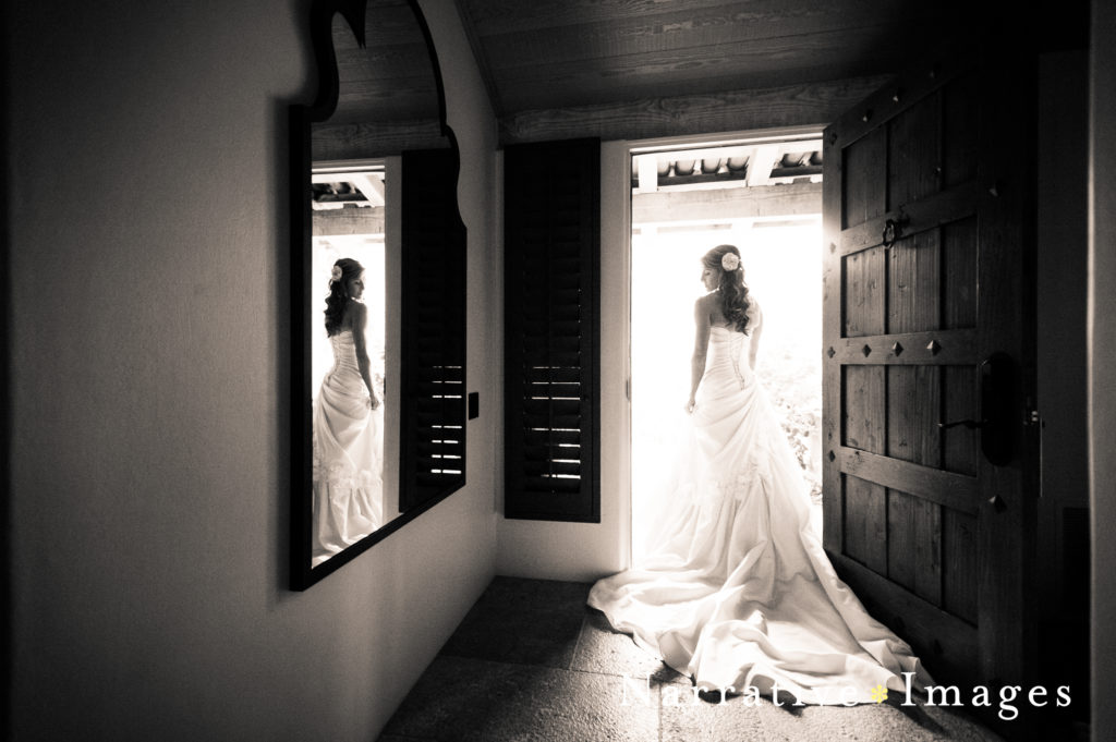 Black and white image of bride in doorway at Rancho Valencia Resort and Spa in Rancho Santa Fe