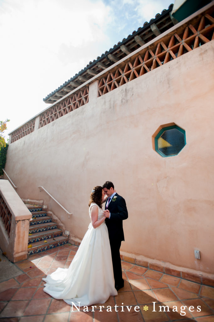 Bride and Groom kiss in front of spanish tile staircase at Rancho Valencia Resort and Spa in Rancho Santa Fe
