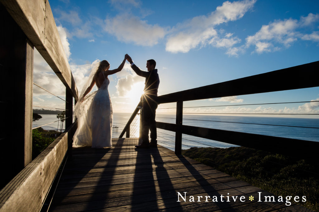 Silhouette of groom twirling bride at Scripps Beach in La Jolla, California